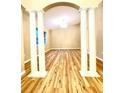 Spacious living area with hardwood floors and columns at 2105 Vickery Ln, Dover, FL 33527