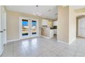 Dining room with tile floors, french doors, and kitchen access at 7864 Jayman Rd, North Port, FL 34291