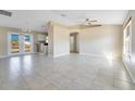 Open living room with tile floors and access to the kitchen at 7864 Jayman Rd, North Port, FL 34291