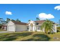 Single-story house with a white exterior, a two-car garage, and a landscaped yard at 14248 Salvatierra Ln, Port Charlotte, FL 33981