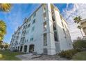 Side view of a multi-story building, highlighting its exterior and landscaping at 210 3Rd W St # 8205, Bradenton, FL 34205