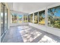 Bright sunroom with tiled floor and view of backyard at 2315 Snowflake Ln, North Port, FL 34286