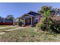 House exterior showcasing a walkway and blooming flowers at 7108 N 10Th St, Tampa, FL 33604