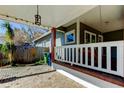 Inviting front porch with a white railing and a swing at 7108 N 10Th St, Tampa, FL 33604