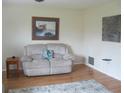 Living room with recliner, end table, and hardwood floors at 1000 Osceola Blvd, Englewood, FL 34223