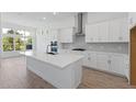 Bright kitchen with white cabinets, an island, and stainless steel appliances at 1003 Signet Dr, Apollo Beach, FL 33572