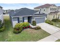 This single story house boasts a gray exterior, neatly landscaped yard and a two car garage at 9474 Sanders Park Pl, Seffner, FL 33584