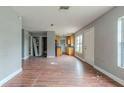 Open living room and kitchen area with wood flooring at 4212 Empire Pl, Tampa, FL 33610