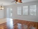 Living room with hardwood and tile floors, and sliding glass doors at 706 Fern Leaf Dr, Ruskin, FL 33570