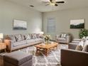 Bright living room featuring comfortable seating and a large area rug at 2428 Roanoke Springs Dr, Ruskin, FL 33570