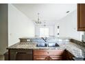 Kitchen island with granite countertop and a double sink at 12600 Jillian Cir, Hudson, FL 34669