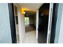 Bright entryway with view of living room and patio doors at 2860 Somerset Park Dr # 203, Tampa, FL 33613