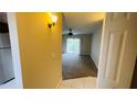 View of living room from kitchen, carpeted and bright at 2860 Somerset Park Dr # 203, Tampa, FL 33613