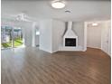 Open living area with hardwood floors and fireplace at 2956 Laurel Ct, Dunedin, FL 34698