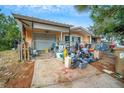 Side view of a house with cluttered yard and driveway at 4119 Beacon Square Dr, Holiday, FL 34691