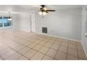 Open living area with tile flooring and plenty of natural light at 1414 Wickham Ln, Holiday, FL 34691