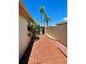Charming side yard with a brick pathway and lush tropical plants at 514 Boca Ciega Point N Blvd, St Petersburg, FL 33708