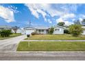Gray house with a green lawn and a two-car garage at 11095 56Th N Ave, Seminole, FL 33772