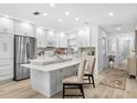 Modern kitchen featuring white cabinets and a large island at 2322 Riverbluff Pkwy # V250, Sarasota, FL 34231