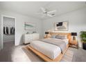 Bright bedroom with light wood platform bed and walk-in closet at 13 Perimeter Dr, Englewood, FL 34223