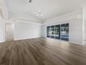 Spacious living room with a view of the pool and sliding glass doors at 13 Perimeter Dr, Englewood, FL 34223