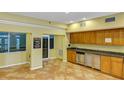 Community kitchen with wood cabinets and granite countertops at 2400 Feather Sound Dr # 613, Clearwater, FL 33762