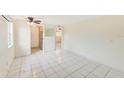 Bright living room with tile floors and kitchen access at 2600 N Paula Dr # 19A, Dunedin, FL 34698