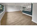 Open concept living space featuring light wood flooring and a modern kitchen at 2801 65Th N Way, St Petersburg, FL 33710