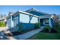 Blue house with a two-car garage and walkway at 3514 Shimmering Oaks Dr, Parrish, FL 34219