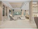 Open living room with large sectional sofa and built in shelving at 9044 Luna Ln, Sarasota, FL 34241