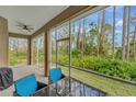 Screened porch with outdoor furniture overlooking a private backyard at 7 Barge Ln, Placida, FL 33946