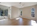 Bright bedroom with wood-look floors and access to the patio at 2559 Comet Ln, North Port, FL 34286