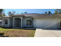 Newly built home with light gray exterior and a two-car garage at 2559 Comet Ln, North Port, FL 34286