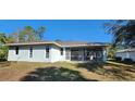 Rear view of the house showcasing a screened patio at 2559 Comet Ln, North Port, FL 34286