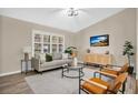 Modern living room with light walls, wood floors, and comfy seating at 6201 Cedarbrook N Dr, Pinellas Park, FL 33782