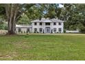 Two-story home with columns, light-colored siding, and a well-manicured lawn at 1001 Edgemont Pl, Brandon, FL 33511