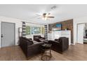 Spacious living room featuring dark leather furniture and a brick accent wall at 1621 S Jefferson Ave, Clearwater, FL 33756