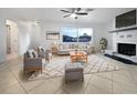 Bright living room featuring fireplace, tiled floors, and comfy seating at 5339 Brookmeade Dr, Sarasota, FL 34232
