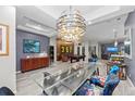 Elegant dining room with glass table, unique chairs, and a stunning chandelier at 7419 Roxye Ln, Sarasota, FL 34240