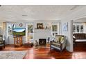 Living room with hardwood floors, fireplace, and view into another room at 3000 21St S Ave, St Petersburg, FL 33712