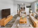 Bright living room featuring hardwood floors, comfortable seating, and a view to the dining area at 5466 9Th N Ave, St Petersburg, FL 33710