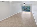 Spacious living room featuring tile flooring and sliding glass doors at 705 S Village N Dr # 205, St Petersburg, FL 33716