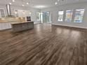 Open living area showcasing wood-look floors at 4739 Butler National Dr, Wesley Chapel, FL 33543