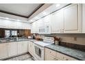 White kitchen with granite countertops and stainless steel appliances at 5711 Avista Dr # 4110, Sarasota, FL 34243