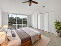 Bright bedroom with large windows, walk-in closet, and tiled floors at 9416 Citrus Glen Pl, Tampa, FL 33618