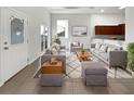 Bright living room with gray sofas, wooden coffee table, and large windows at 9416 Citrus Glen Pl, Tampa, FL 33618