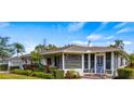 White single story home with a gray door and landscaped yard at 105 17Th Ne Ave, St Petersburg, FL 33704