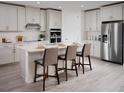 Modern kitchen featuring white cabinets, quartz countertops, and stainless steel appliances at 1856 Draughton Dr, Zephyrhills, FL 33541