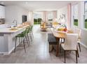 Open concept dining area with wood table and seating, adjacent to kitchen at 1868 Brekey Way, Zephyrhills, FL 33541