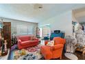 Spacious living room with coral colored furniture at 2101 Sunset Point Rd # 2304, Clearwater, FL 33765